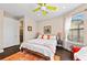 Bright bedroom with hardwood floors, modern ceiling fan, and neutral tones at 16741 Ellsworth Ave, Bradenton, FL 34202