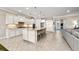 Spacious kitchen with white cabinets, a large island with seating, and modern appliances for cooking and entertaining at 16741 Ellsworth Ave, Bradenton, FL 34202