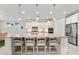 A kitchen island offers ample seating, stone countertops, pendant lighting and stainless steel appliances at 16741 Ellsworth Ave, Bradenton, FL 34202