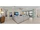 Bright living room with an oversized sectional, a media center, and large sliding doors that open to the outdoor space at 16741 Ellsworth Ave, Bradenton, FL 34202