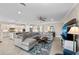 Comfortable living room features a large gray sectional sofa, a blue patterned rug, and access to an open concept kitchen at 16741 Ellsworth Ave, Bradenton, FL 34202