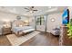 Main bedroom with hardwood floors, modern ceiling fan, and sitting area at 16741 Ellsworth Ave, Bradenton, FL 34202