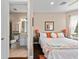 Bedroom showcasing ensuite bathroom, hardwood floors and natural light at 16741 Ellsworth Ave, Bradenton, FL 34202