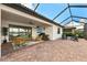 Spacious screened-in patio has brick pavers with a full outdoor seating and dining area at 16741 Ellsworth Ave, Bradenton, FL 34202