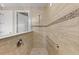 Modern shower featuring neutral tile, glass partition, and convenient grab bar at 16741 Ellsworth Ave, Bradenton, FL 34202