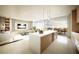 Modern open concept kitchen with stainless steel appliances and a large island with bar seating at 1703 Main St # Ph 3, Sarasota, FL 34236