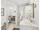 Well-lit bathroom featuring a vanity with marble countertops and a separate toilet room at 1950 Alta Vista St, Sarasota, FL 34236