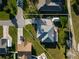 Aerial view of home featuring a well maintained lawn, covered patio, and convenient driveway with parking at 222 Pine Glen Ct, Englewood, FL 34223