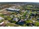 An aerial view of the property in its neighborhood, showing surrounding homes and community features at 222 Pine Glen Ct, Englewood, FL 34223
