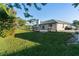 Rear of home featuring a well maintained lawn and a spacious patio at 222 Pine Glen Ct, Englewood, FL 34223