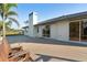 Rear of home featuring a large patio and sliding glass doors, great for entertaining at 222 Pine Glen Ct, Englewood, FL 34223
