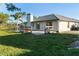 Large backyard with new landscaping, a patio, and a privacy fence at 222 Pine Glen Ct, Englewood, FL 34223