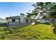 Large backyard with mature trees, a spacious patio, and new landscaping at 222 Pine Glen Ct, Englewood, FL 34223