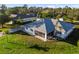 Rear exterior of the property with spacious yard and inviting screened in lanai at 222 Pine Glen Ct, Englewood, FL 34223