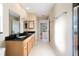 Bathroom features double sinks, granite counters and wood cabinets at 222 Pine Glen Ct, Englewood, FL 34223