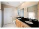 Bathroom features double sinks, granite counters, tile floors, walk-in shower and wood cabinets at 222 Pine Glen Ct, Englewood, FL 34223