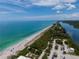 Expansive aerial view of a sandy beach, capturing its scenic coastline and tranquil blue waters at 222 Pine Glen Ct, Englewood, FL 34223