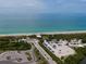 Captivating aerial view of Englewood beach, showing a coastal road and parking leading to sandy shores at 222 Pine Glen Ct, Englewood, FL 34223