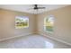 Bedroom with ceiling fan and natural light streaming through windows at 222 Pine Glen Ct, Englewood, FL 34223