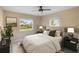 Bedroom with ceiling fan and natural light streaming through windows at 222 Pine Glen Ct, Englewood, FL 34223