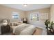 Bedroom with ceiling fan and natural light streaming through windows at 222 Pine Glen Ct, Englewood, FL 34223