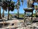 Boardwalk with wooden railings stretches over a sandy path towards the water in the Commodore Street Park at 222 Pine Glen Ct, Englewood, FL 34223