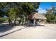 Covered area with sand, large trees, providing shade on a sunny day in Englewood, Florida at 222 Pine Glen Ct, Englewood, FL 34223