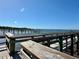 View of the docks and open water from the walkway on a clear day under a bright blue sky at 222 Pine Glen Ct, Englewood, FL 34223