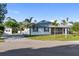 Charming single-story home with a well-maintained yard, screened-in porch, storage shed, and paved driveway at 222 Pine Glen Ct, Englewood, FL 34223