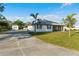 Charming single-story home features a screened lanai, lush lawn, and a long concrete driveway at 222 Pine Glen Ct, Englewood, FL 34223