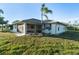 Side exterior of the property with spacious yard and inviting screened in lanai at 222 Pine Glen Ct, Englewood, FL 34223
