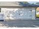 Attached two car garage with a white door and black decorative hardware at 222 Pine Glen Ct, Englewood, FL 34223