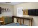 Functional garage featuring a workbench area and storage solutions for organized projects at 222 Pine Glen Ct, Englewood, FL 34223