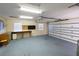 Spacious garage featuring a workbench, shelving, and plenty of storage space at 222 Pine Glen Ct, Englewood, FL 34223