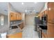 Spacious kitchen with stainless steel appliances, granite countertops, and overhead fan for comfort at 222 Pine Glen Ct, Englewood, FL 34223