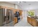 Bright kitchen featuring stainless steel appliances, granite countertops, and ample cabinet space at 222 Pine Glen Ct, Englewood, FL 34223