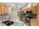 Bright kitchen with stainless steel appliances, granite counters, and ample cabinet space at 222 Pine Glen Ct, Englewood, FL 34223
