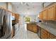 Well-equipped kitchen with stainless steel appliances, granite countertops, and a view to the backyard at 222 Pine Glen Ct, Englewood, FL 34223