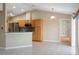 Open kitchen with stainless steel appliances, wooden cabinets, and bar counter overlooking living area at 222 Pine Glen Ct, Englewood, FL 34223