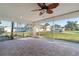 Relaxing screened lanai featuring neutral tile flooring, a ceiling fan, and outdoor views at 222 Pine Glen Ct, Englewood, FL 34223