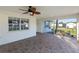 Enclosed lanai featuring neutral tile flooring and a ceiling fan at 222 Pine Glen Ct, Englewood, FL 34223