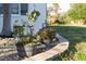 Close-up of a beautifully landscaped area near the house, featuring potted flowers and decorative stone edging at 222 Pine Glen Ct, Englewood, FL 34223