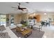 Spacious open-concept living room featuring tile flooring, modern decor, and natural light at 222 Pine Glen Ct, Englewood, FL 34223