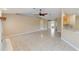 Open living room featuring tile floors, neutral walls, a fireplace, and a ceiling fan at 222 Pine Glen Ct, Englewood, FL 34223