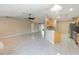 Open-concept living area with tile flooring flowing into the kitchen and featuring ceiling fans for comfort at 222 Pine Glen Ct, Englewood, FL 34223