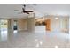 Unfurnished living room featuring tile floors, neutral paint, and vaulted ceiling at 222 Pine Glen Ct, Englewood, FL 34223
