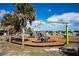 Playground with children and adults enjoying recreational area on a sunny day in Englewood at 222 Pine Glen Ct, Englewood, FL 34223