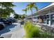 Exterior view of the retail shopping area in Englewood featuring boutiques and palm trees at 222 Pine Glen Ct, Englewood, FL 34223