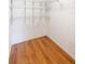 Walk-in closet with wood floors and wire shelving for optimal storage at 222 Pine Glen Ct, Englewood, FL 34223