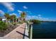 Waterfront view along bricked walkway, palm trees, and water views in beautiful Englewood, Florida at 222 Pine Glen Ct, Englewood, FL 34223